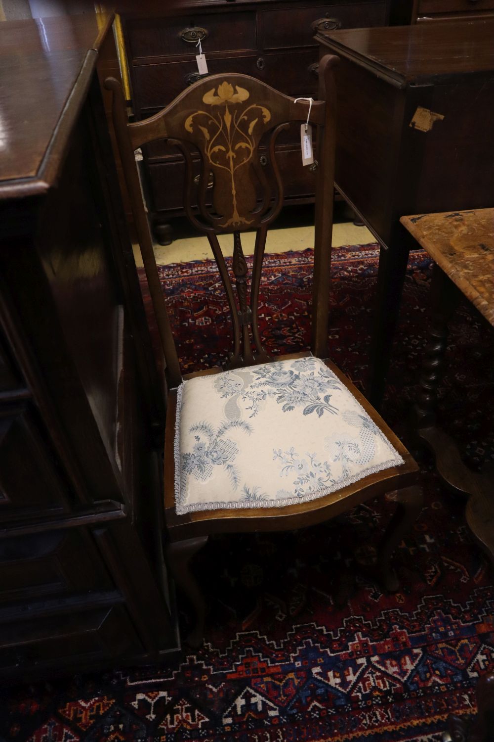 An Art Nouveau style Edwardian inlaid mahogany salon chair and an early Victorian carved rosewood salon chair (2)